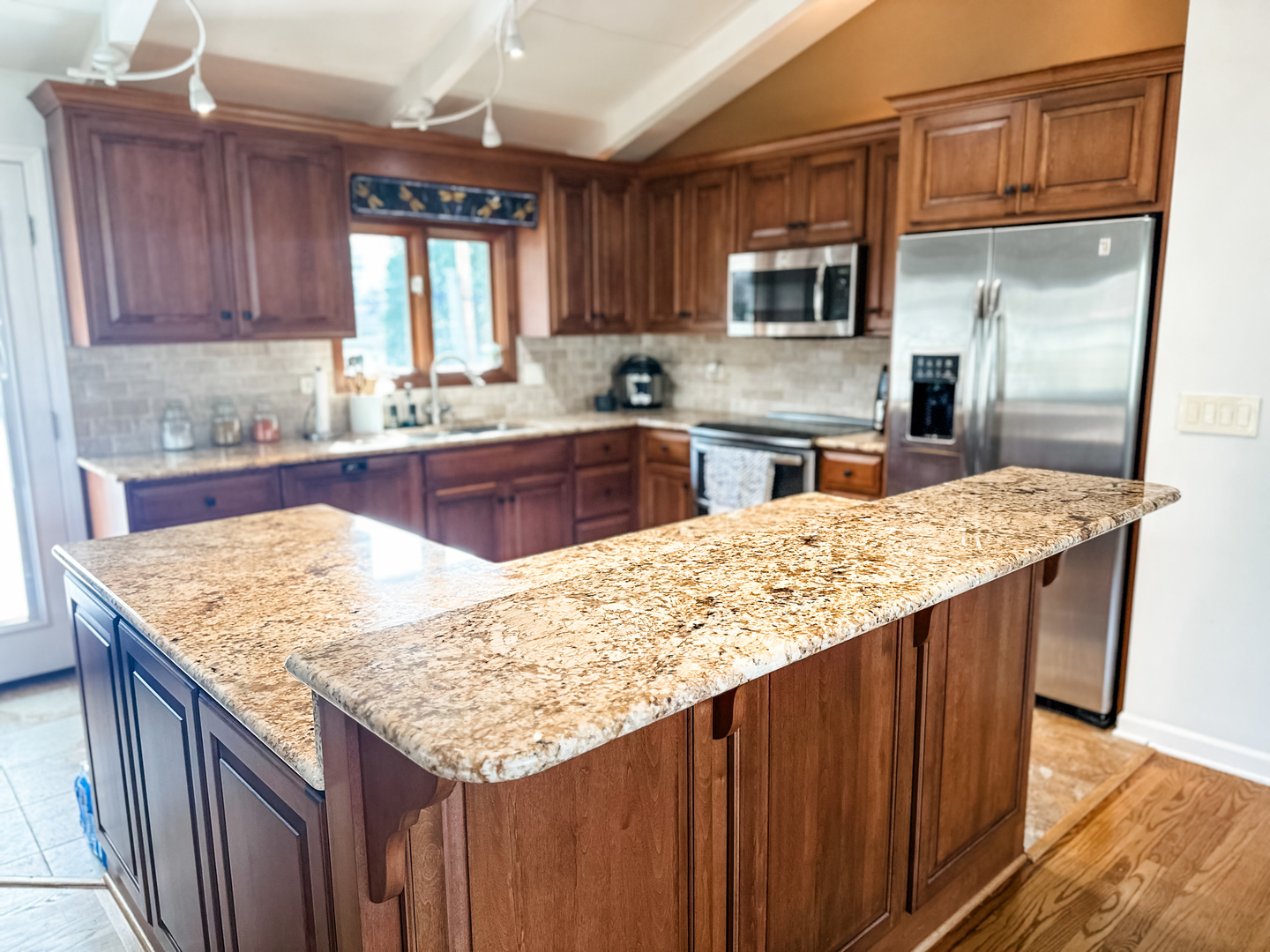 5341 Meadow Lane Lisle, IL 60532 - Photo 3 of 16 a kitchen with stainless steel appliances kitchen island granite countertop wooden cabinets a granite counter tops and a window