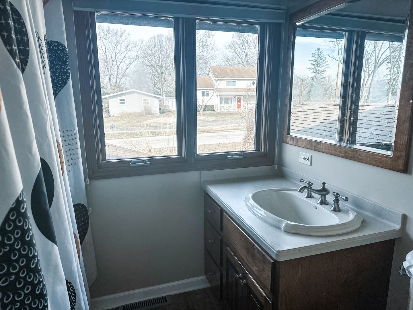 5341 Meadow Lane Lisle, IL 60532 - Photo 7 of 16 a bathroom with a sink a window and a mirror