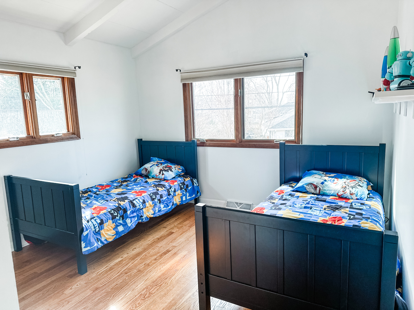 5341 Meadow Lane Lisle, IL 60532 - Photo 8 of 16 a bedroom with a bed that has a blanket on it and next to a window