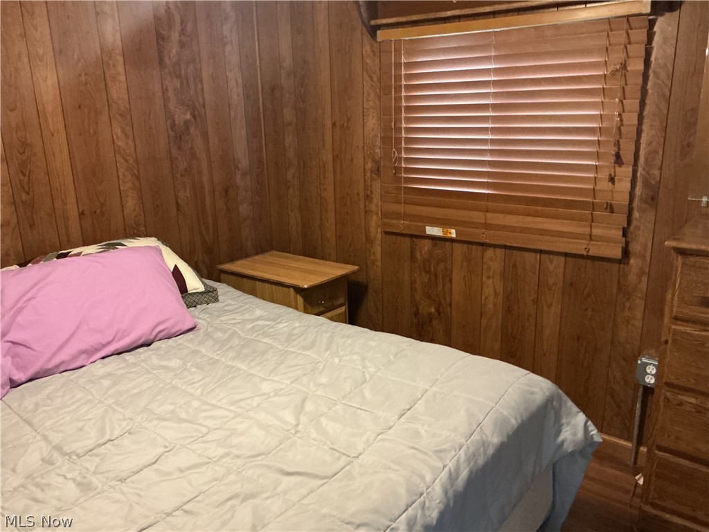 9385 North River Road East, Unit 33 Dresden, OH 43821 - Photo 15 of 19 Bedroom with wooden walls and wood finished floors