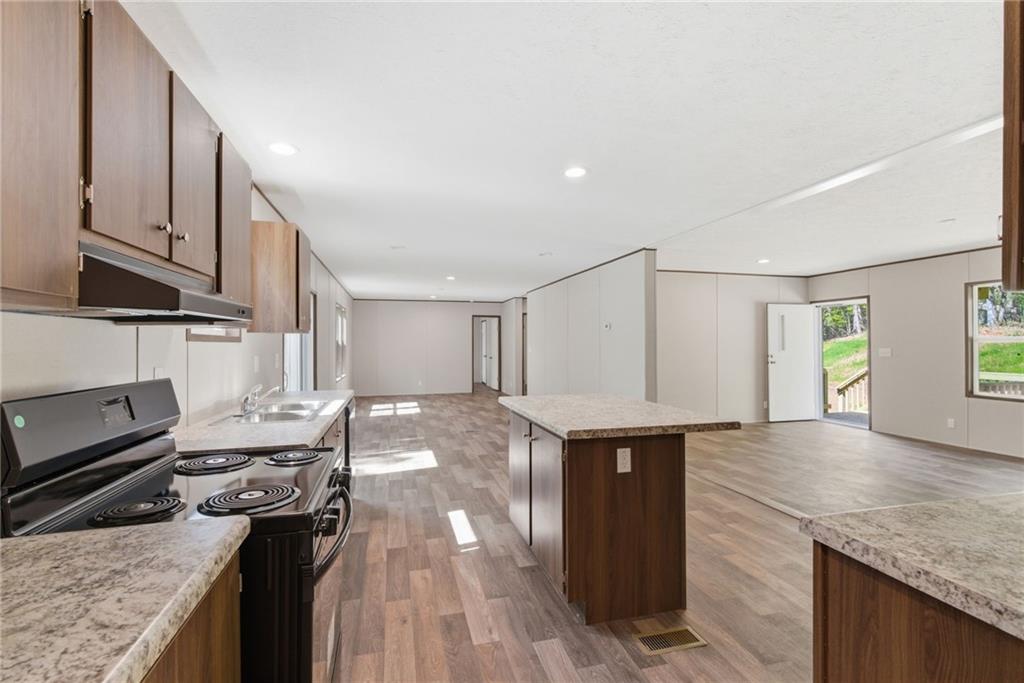 66 Martin Byers Road Dahlonega, GA 30533 - Photo 12 of 32 a kitchen with stainless steel appliances granite countertop a stove and a sink