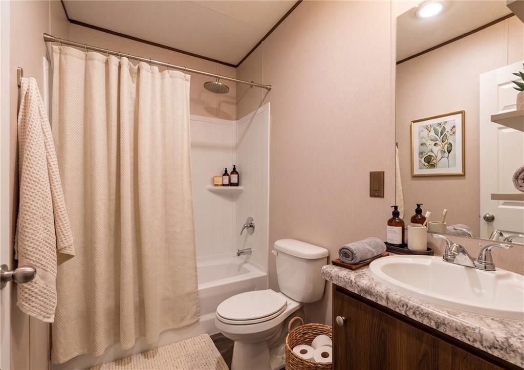 66 Martin Byers Road Dahlonega, GA 30533 - Photo 27 of 32 a bathroom with a granite countertop sink toilet and a mirror