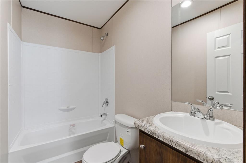 66 Martin Byers Road Dahlonega, GA 30533 - Photo 28 of 32 a bathroom with a granite countertop sink toilet and shower