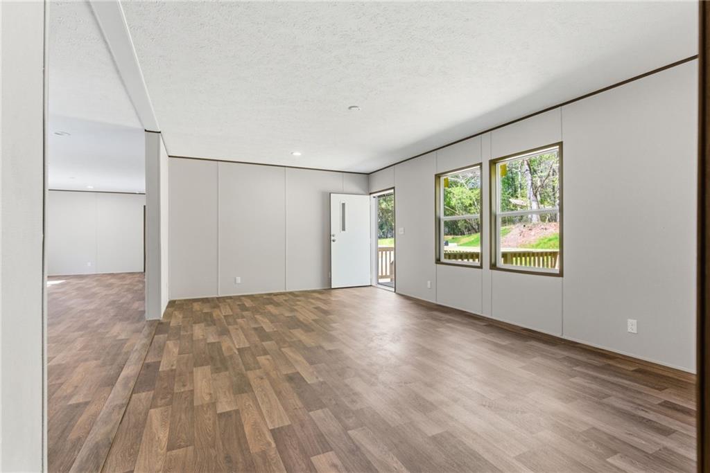 66 Martin Byers Road Dahlonega, GA 30533 - Photo 8 of 32 a view of an empty room with a window and wooden floor