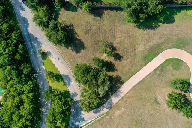 an aerial view of a house with a yard and lake view