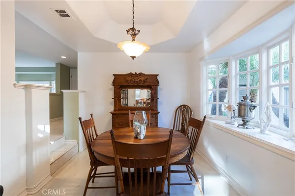 a view of a dining room with furniture and window