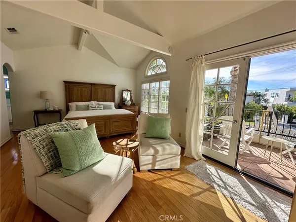 a bedroom with furniture and large windows