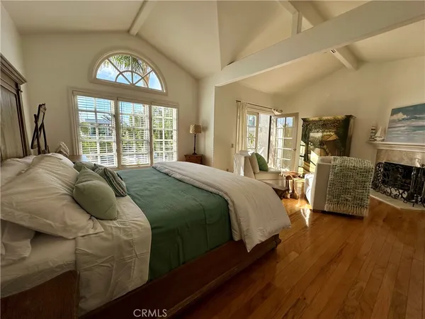 a spacious bedroom with a bed and a large window