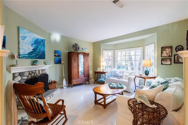 a living room with furniture a rug and a window
