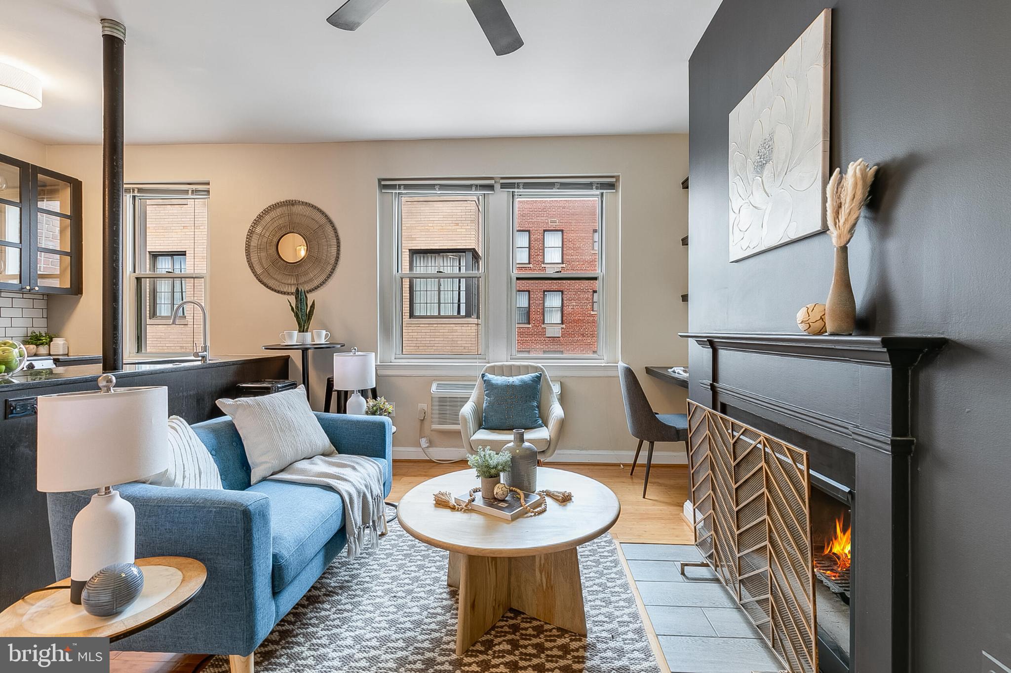 a living room with furniture a fireplace and a large mirror