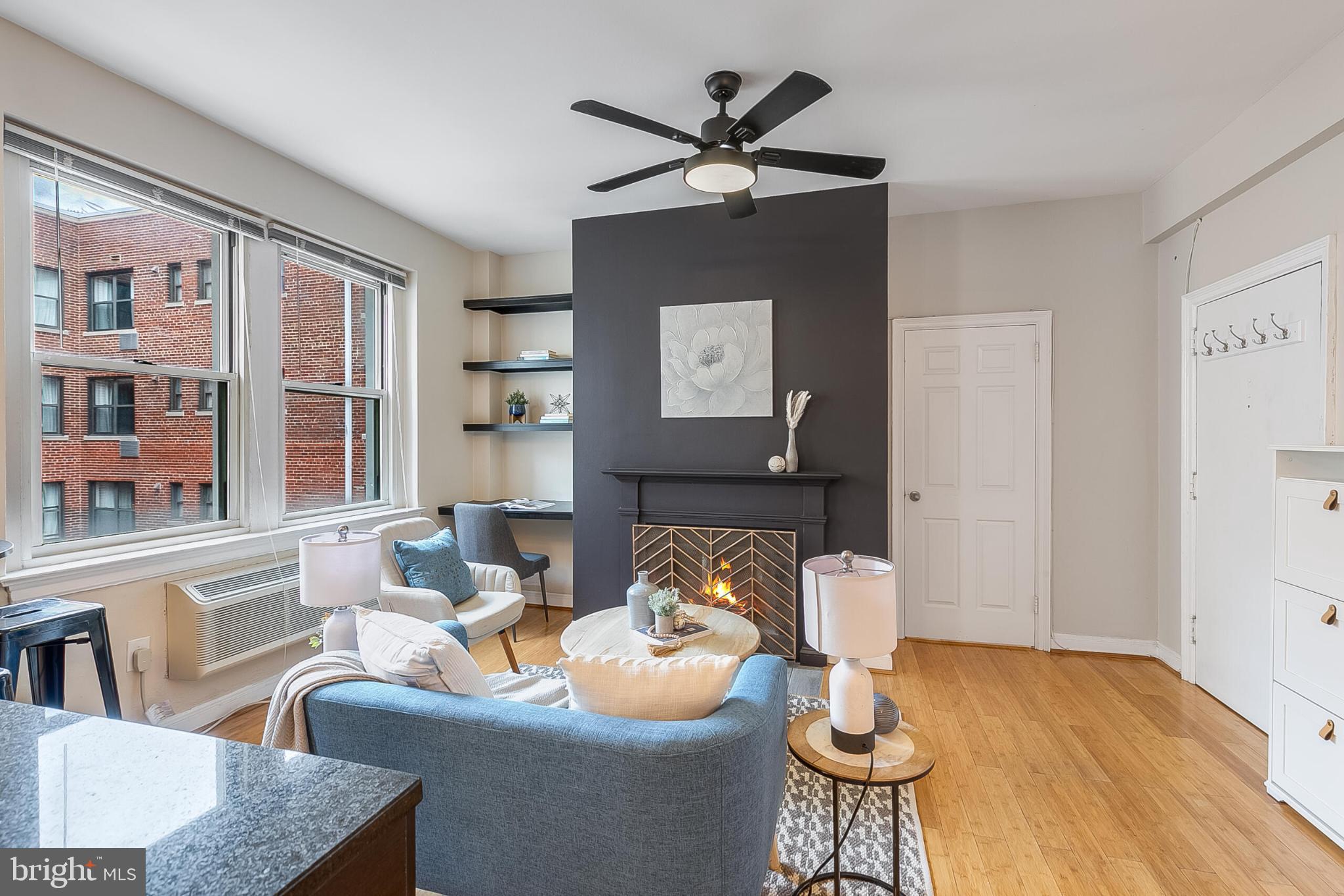 1725 New Hampshire Avenue Northwest, Unit 703 Washington, DC 20009 - Photo 2 of 16 a living room with furniture and a window