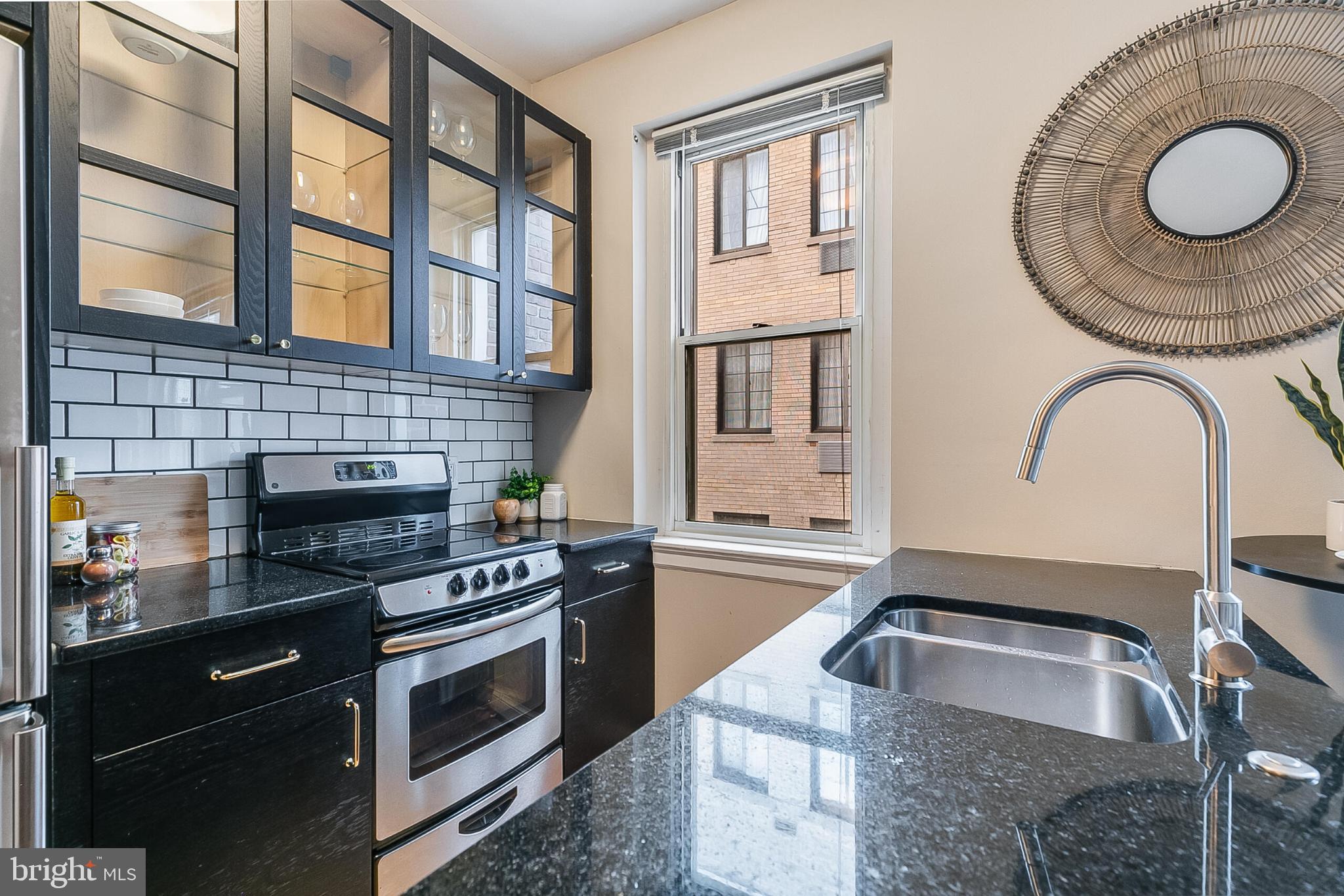 1725 New Hampshire Avenue Northwest, Unit 703 Washington, DC 20009 - Photo 7 of 16 a kitchen with a stove and a sink