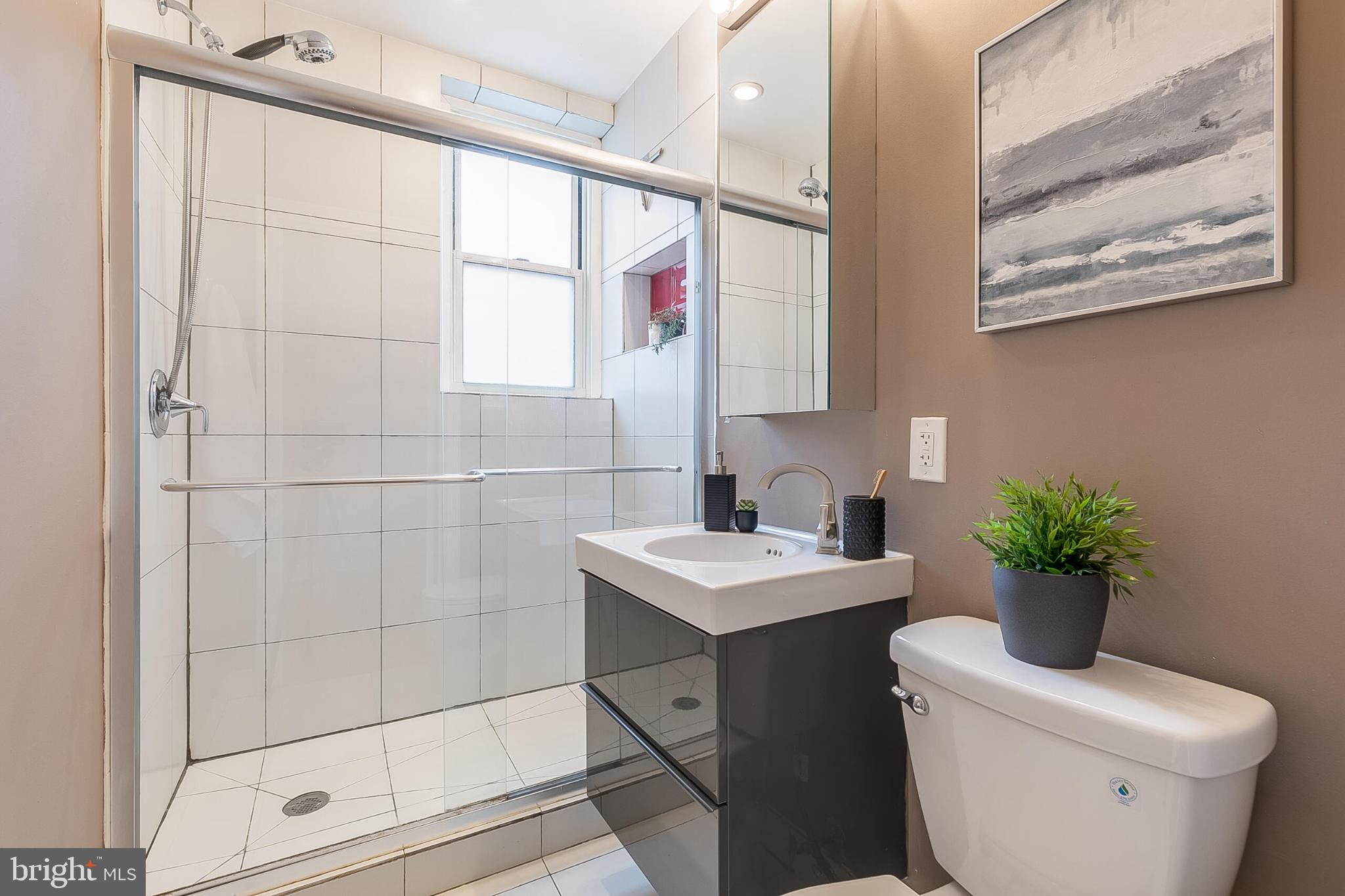 1725 New Hampshire Avenue Northwest, Unit 703 Washington, DC 20009 - Photo 10 of 16 a bathroom with a sink toilet and shower