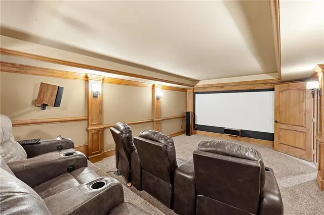 a view of an empty room with wooden floor and windows