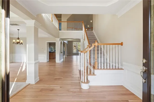 a view of entryway and hall with wooden floor