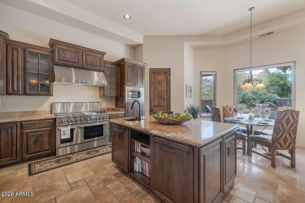18507 East Picacho Road Rio Verde, AZ 85263 - Photo 5 of 33 a kitchen with stainless steel appliances granite countertop a stove oven and a sink