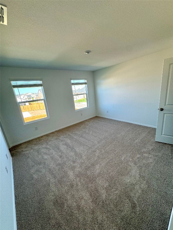 110 Haw Branch View Kyle, TX 78640 - Photo 9 of 15 Carpeted empty room featuring baseboards and a textured ceiling