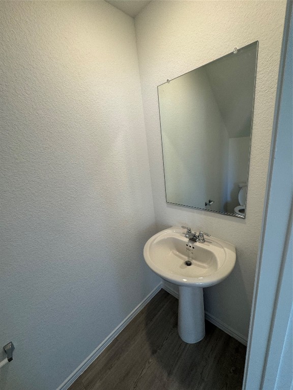 110 Haw Branch View Kyle, TX 78640 - Photo 3 of 15 Bathroom featuring dark wood-style floors and a textured wall