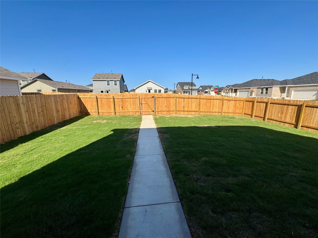110 Haw Branch View Kyle, TX 78640 - Photo 5 of 15 Fenced backyard with a residential view