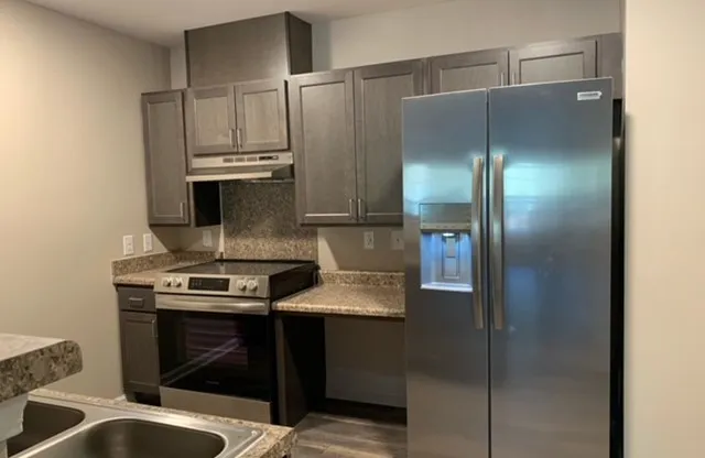 a kitchen with a stove and a refrigerator