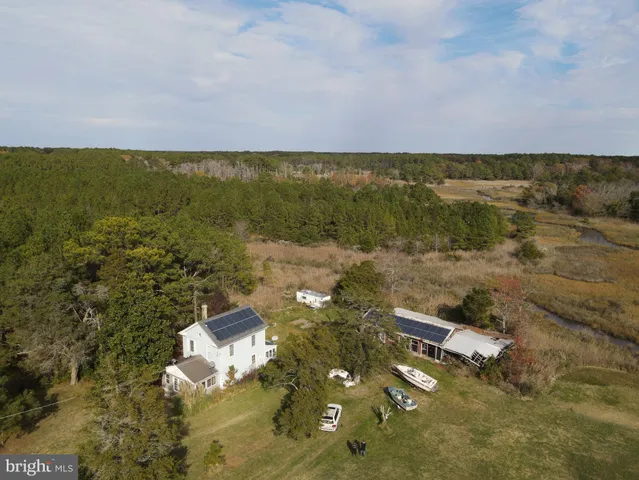 an aerial view of ocean with residential houses with outdoor space