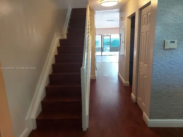 a view of entryway and hall with wooden floor