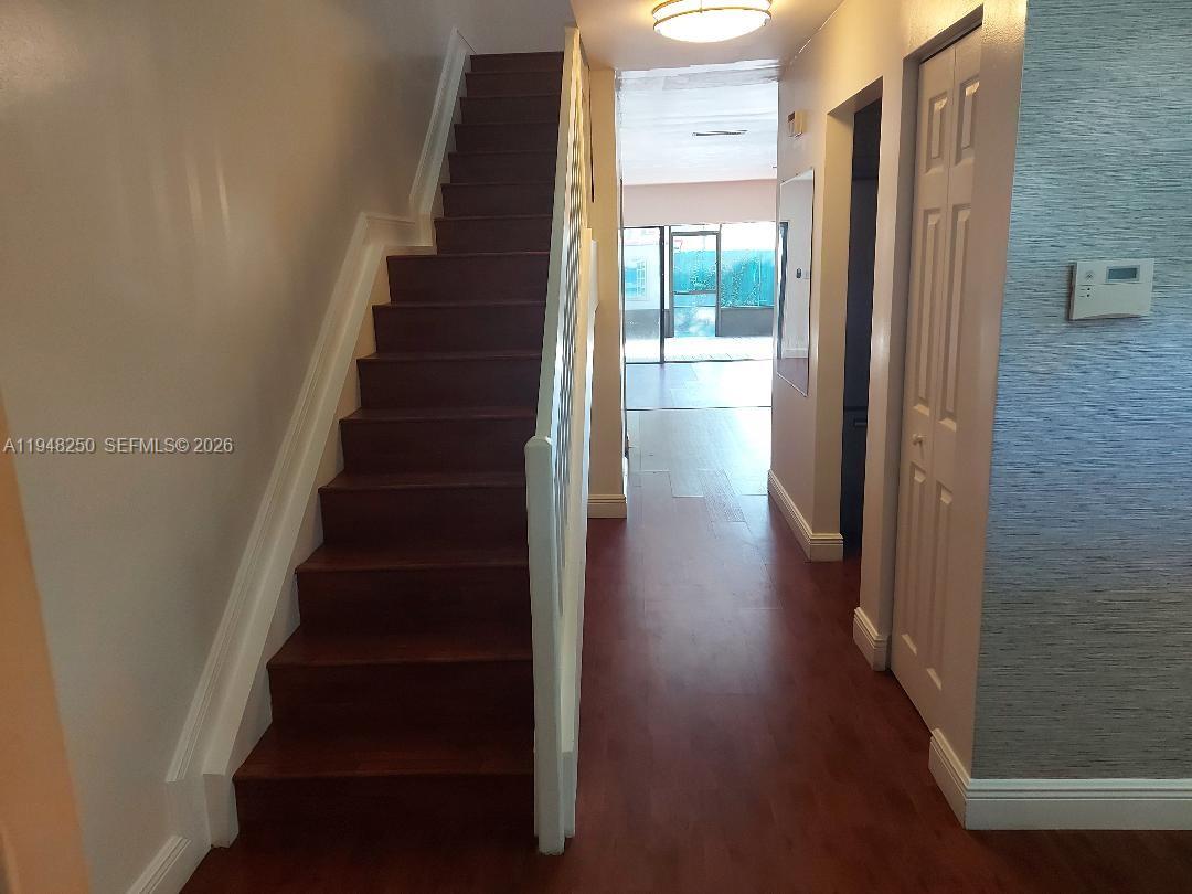 20033 Northeast 2nd Place Miami, FL 33179 - Photo 18 of 23 a view of entryway and hall with wooden floor