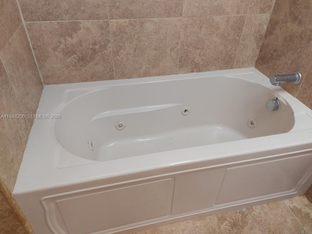 20033 Northeast 2nd Place Miami, FL 33179 - Photo 10 of 23 a bathroom with bathtub