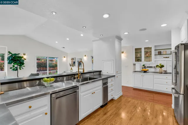 a kitchen with stainless steel appliances granite countertop a sink and cabinets