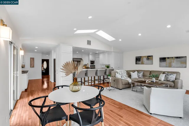 a living room with furniture a dining table and chairs