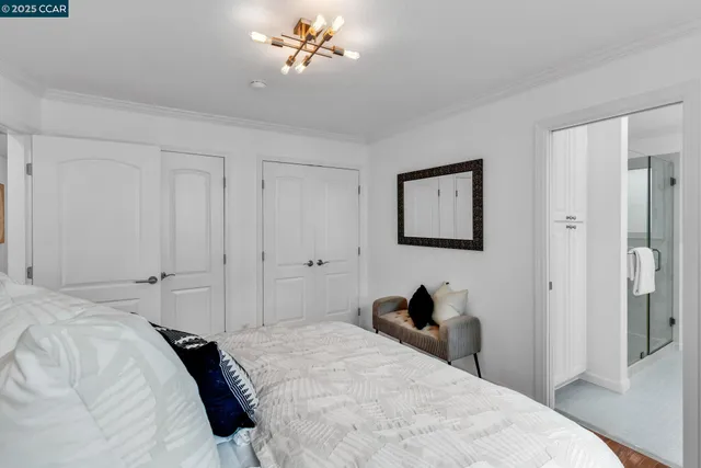 a bedroom with a bed and a chandelier