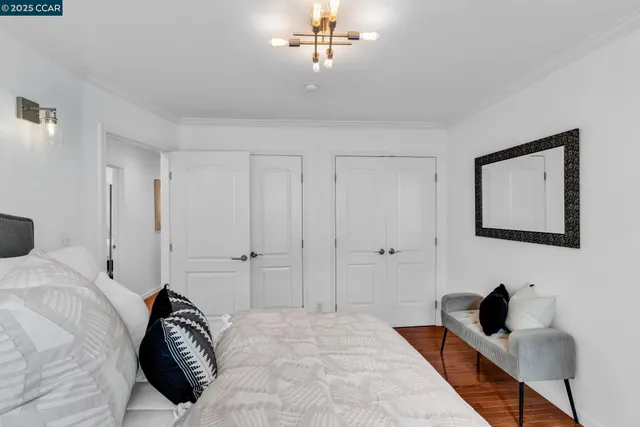 a bedroom with a bed and a chandelier