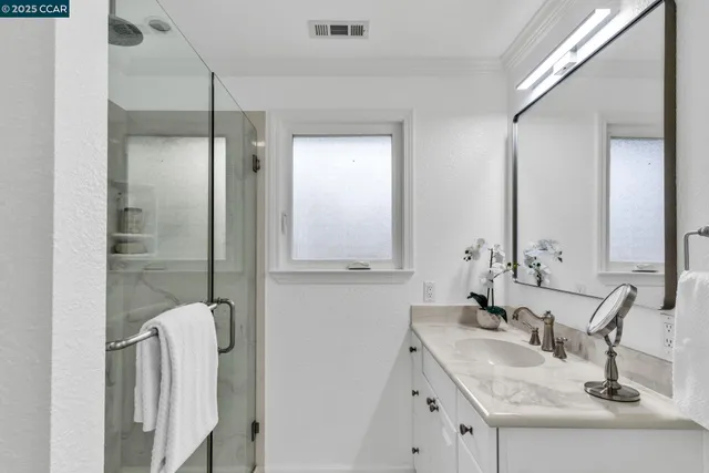a bathroom with double vanity sink and a mirror