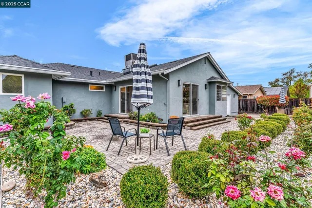 a view of a chair and tables in the patio of the house