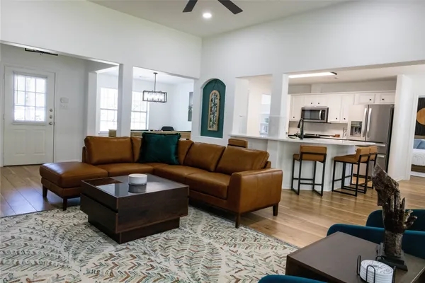 a living room with furniture and wooden floor