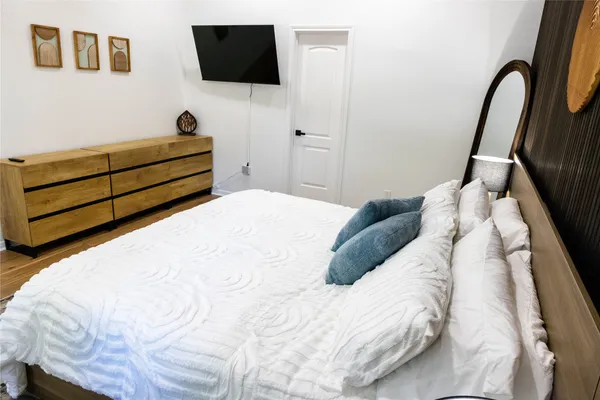 a bedroom with a bed and a flat screen tv