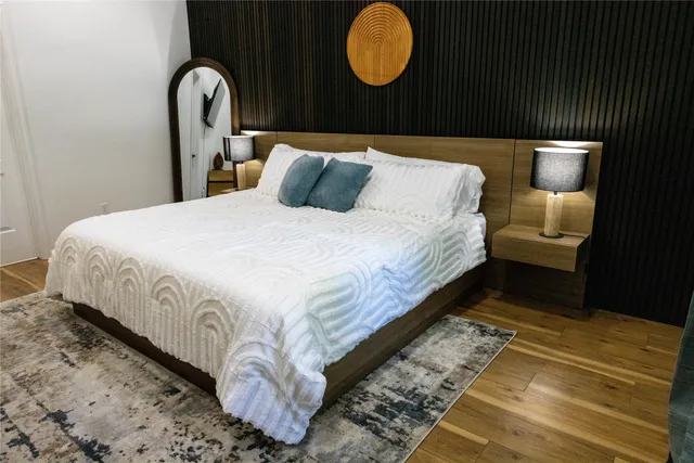 a bedroom with a bed next to a window