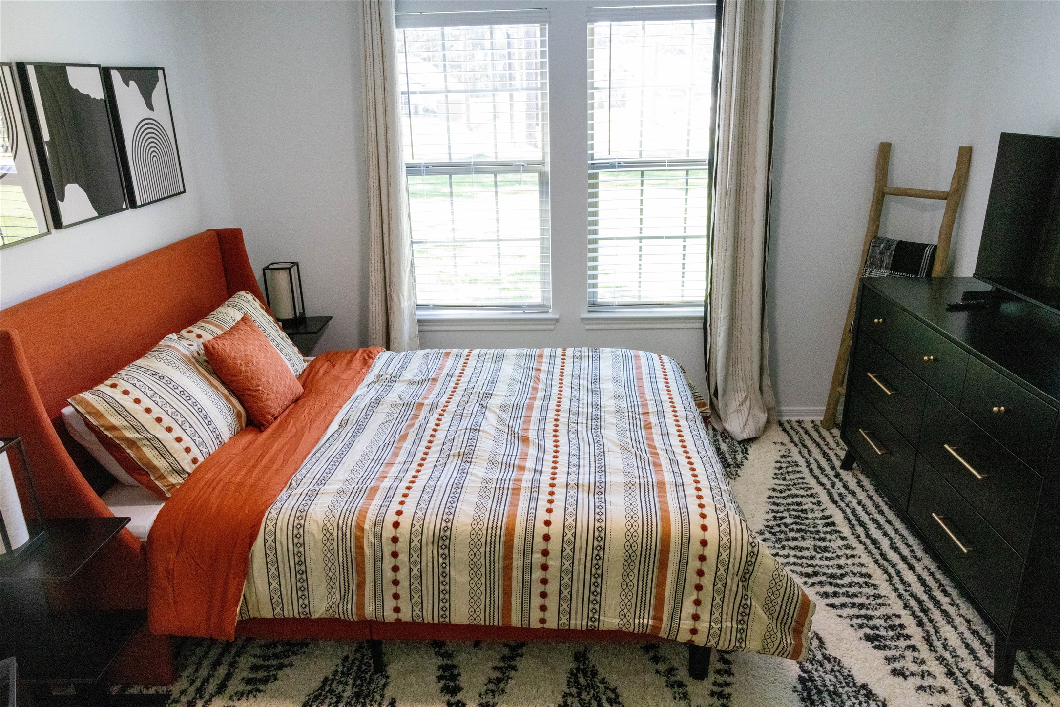 17023 Lexington Drive Conroe, TX 77385 - Photo 18 of 25 a bedroom with a bed and wooden floor