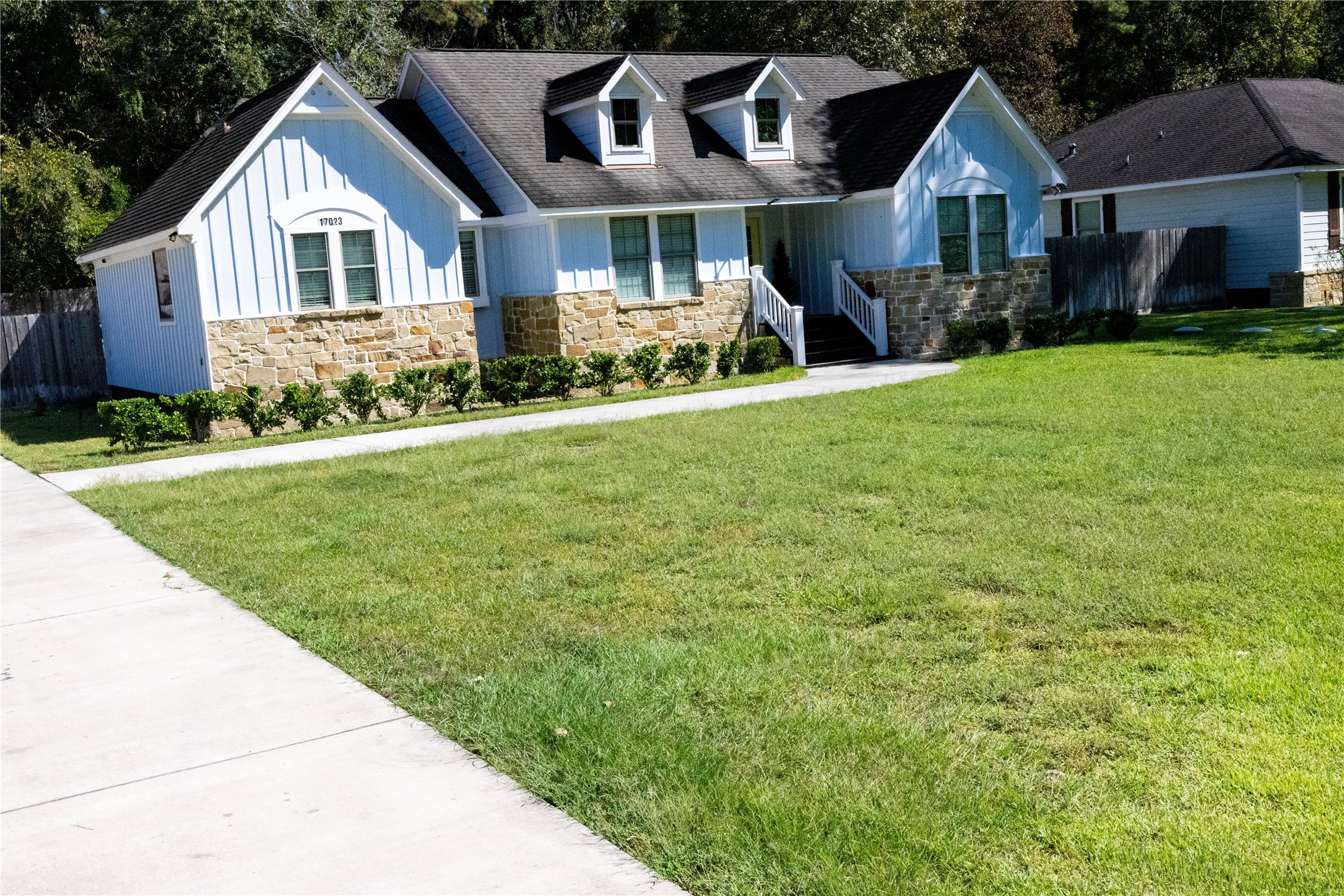 17023 Lexington Drive Conroe, TX 77385 - Photo 22 of 25 a front view of a house with a garden and trees