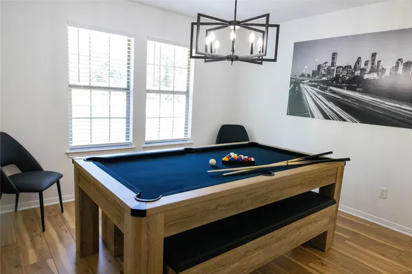 a room with pool table and windows