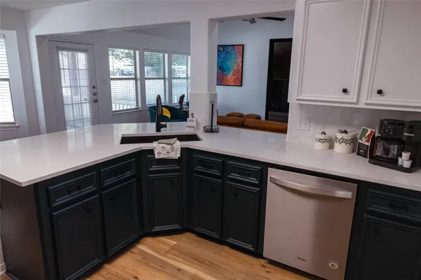 a kitchen with a sink and cabinets
