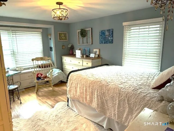 a spacious bedroom with a bed and a chandelier