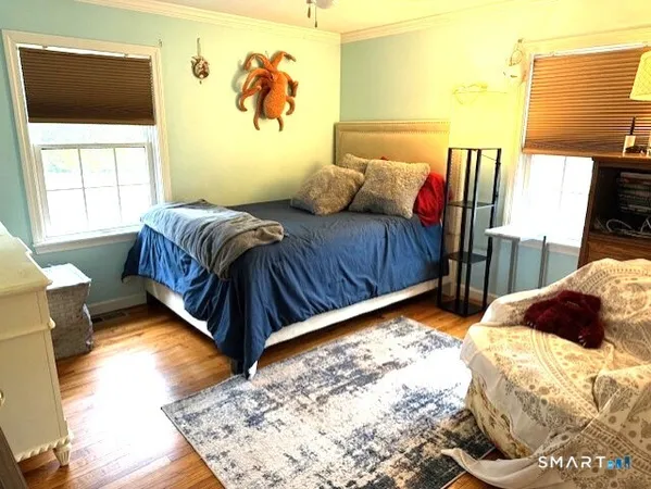 a bedroom with a bed and window