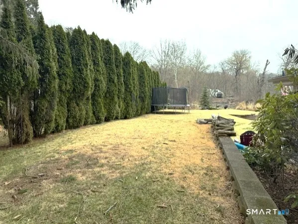 a swimming pool with trees in the background
