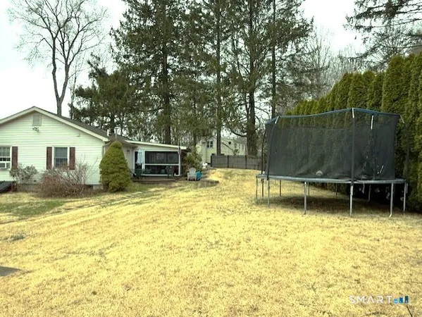 a backyard of a house with table and chairs