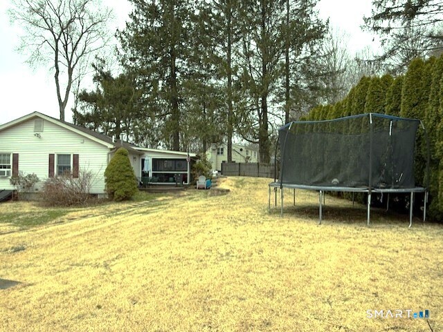 215 Whisconier Road Brookfield, CT 06804 - Photo 31 of 32 a backyard of a house with table and chairs