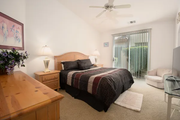a bedroom with bed and a flat screen tv