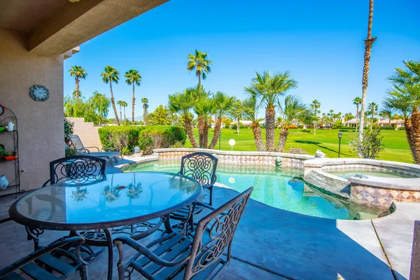 a view of a swimming pool with a patio