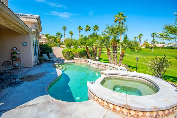 a view of swimming pool with a garden and seating area