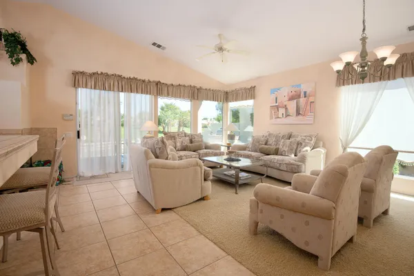 a large white kitchen with a large window